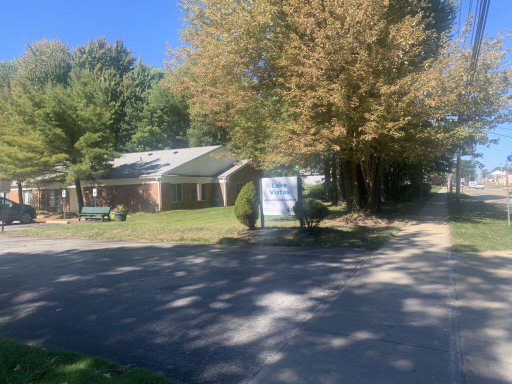[Image] Distant photo of Lake Vistas building, sun in shinning and trees are changing into fall colors.